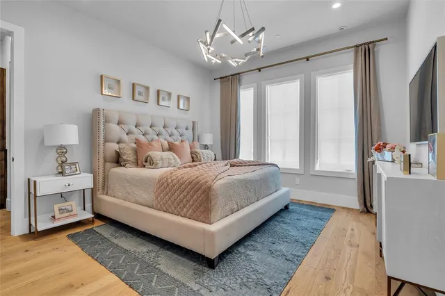 a spacious bedroom with a bed and ceiling fan