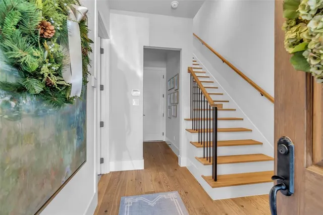 a view of entryway and hall with wooden floor