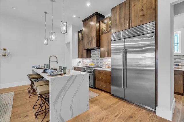 a kitchen with kitchen island a counter top space appliances and cabinets
