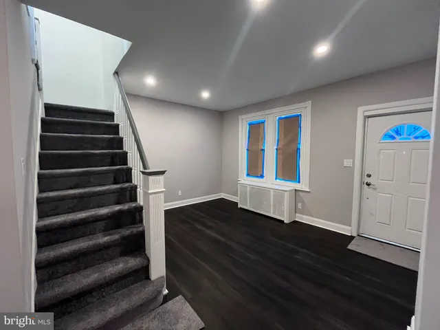 a view of entryway with wooden floor and stairs