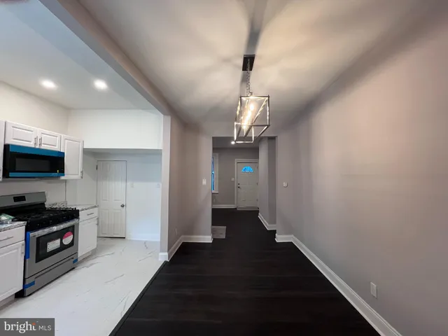 a view of a kitchen from the hallway