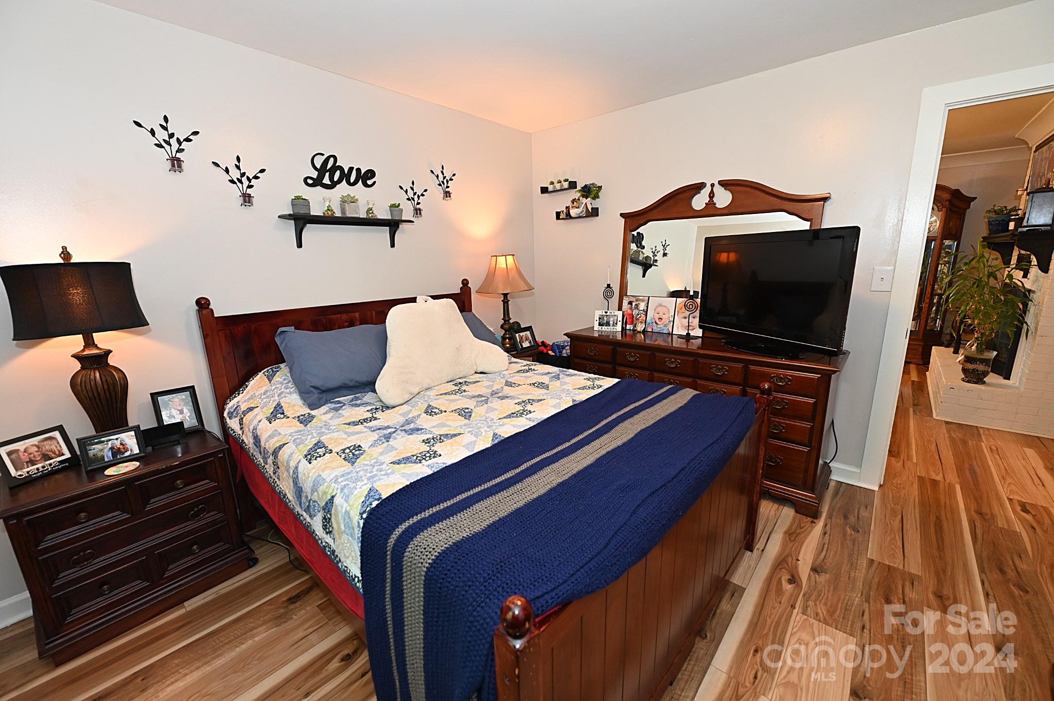 110 Sunny Lane Cherryville, NC 28021 - Photo 15 of 26 a bedroom with a bed and wooden floor