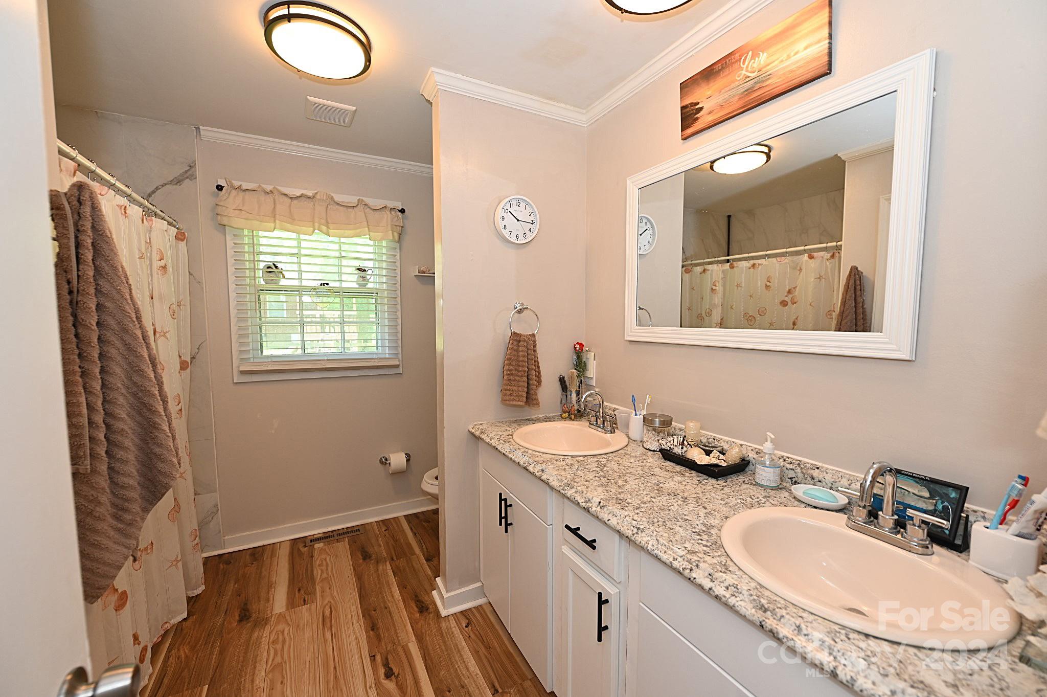 110 Sunny Lane Cherryville, NC 28021 - Photo 17 of 26 a bathroom with a granite countertop sink mirror vanity and a shower