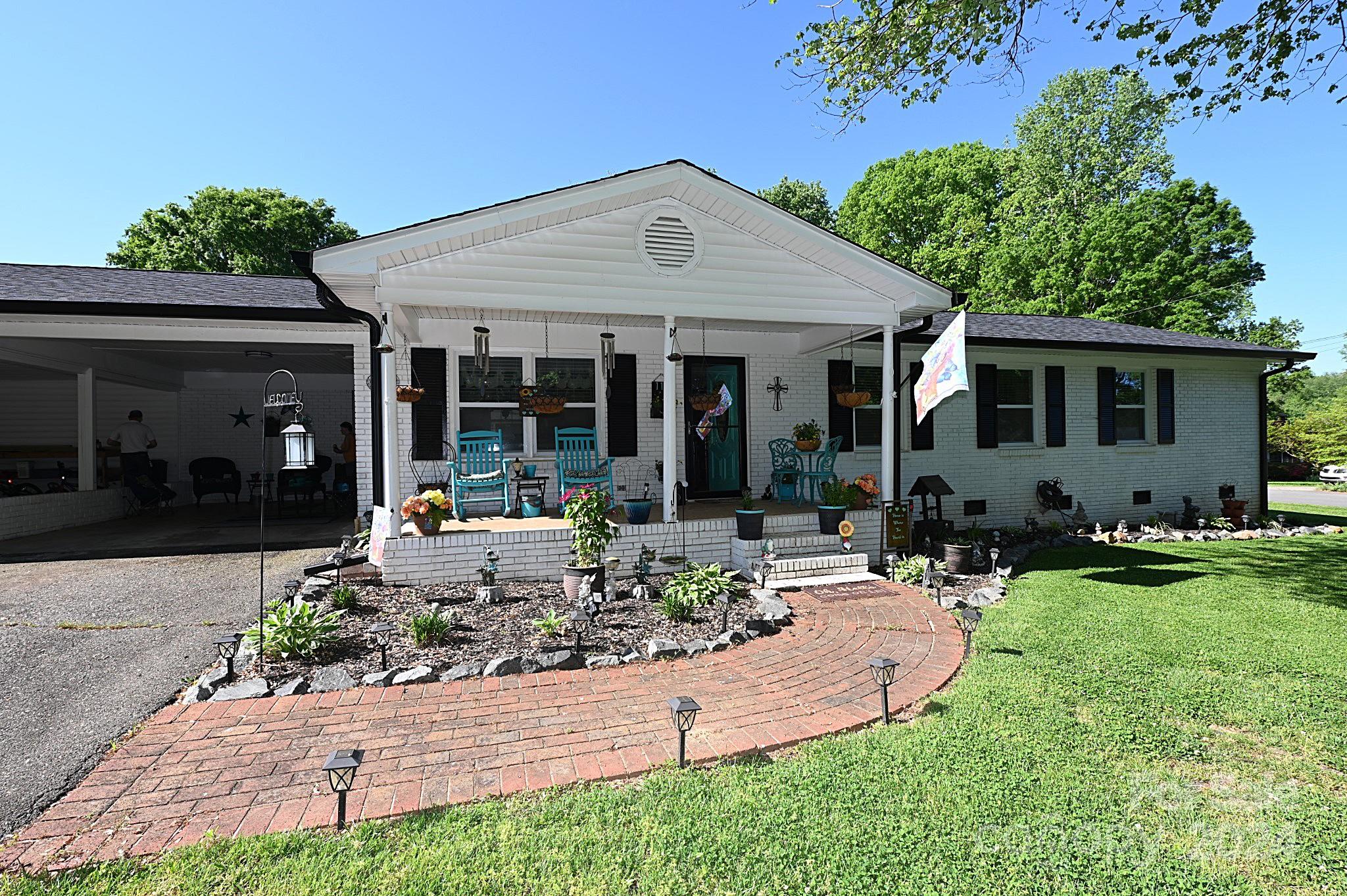 110 Sunny Lane Cherryville, NC 28021 - Photo 2 of 26 a front view of a house with porch and garden