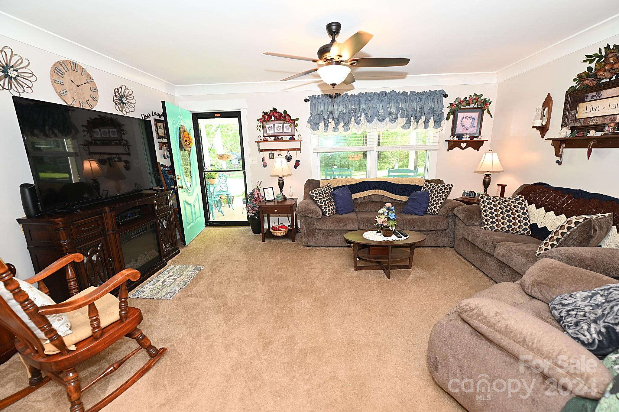 110 Sunny Lane Cherryville, NC 28021 - Photo 10 of 26 a living room with furniture a flat screen tv and floor to ceiling window