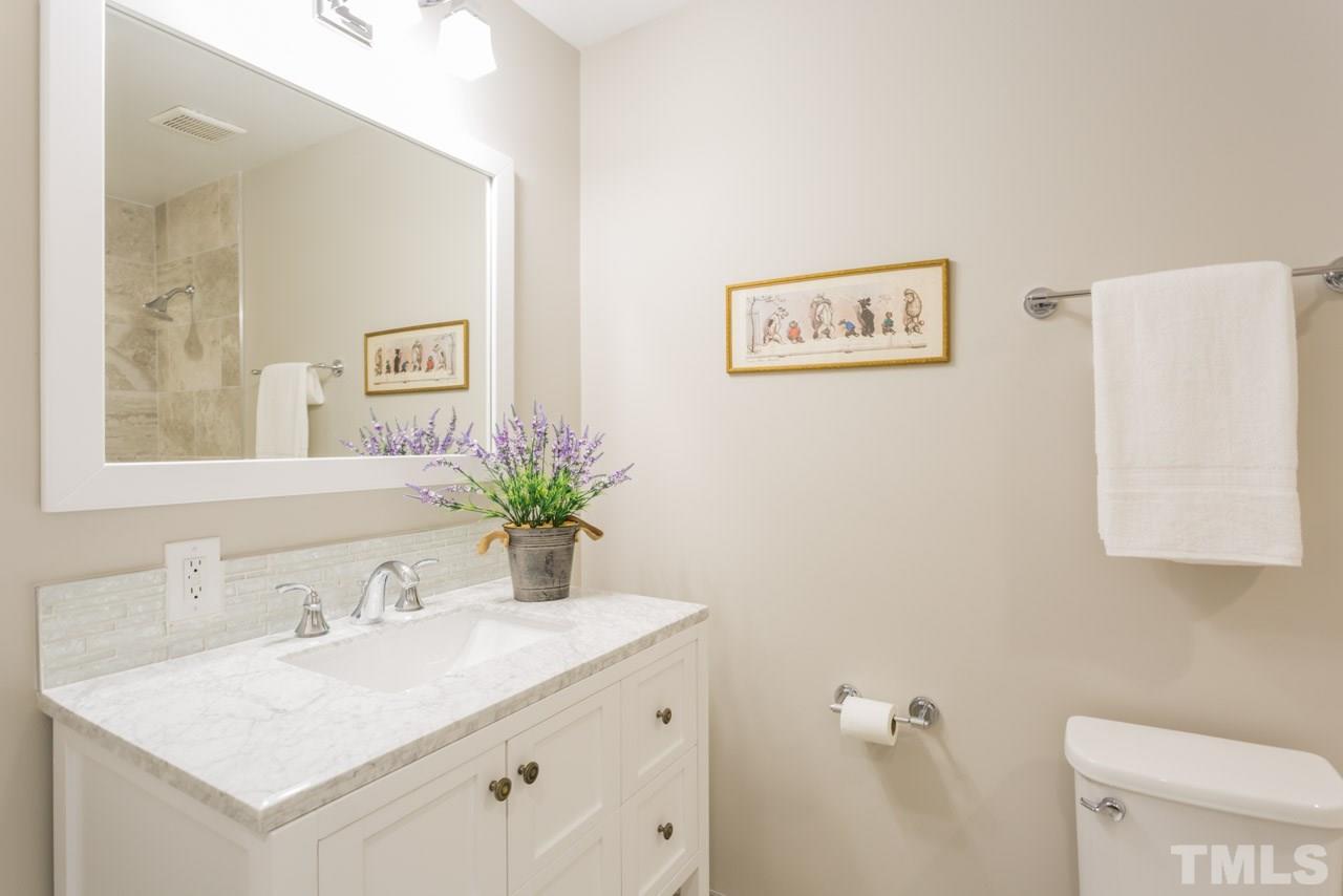 3705 Edwards Mill Road Raleigh, NC 27612 - Photo 5 of 25 a bathroom with a granite countertop sink and a mirror