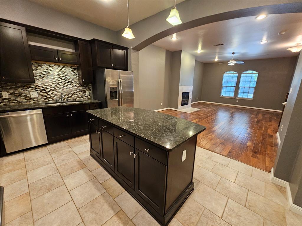 8627 Calvin Road Irving, TX 75063 - Photo 11 of 33 a kitchen with stainless steel appliances granite countertop a sink and a microwave