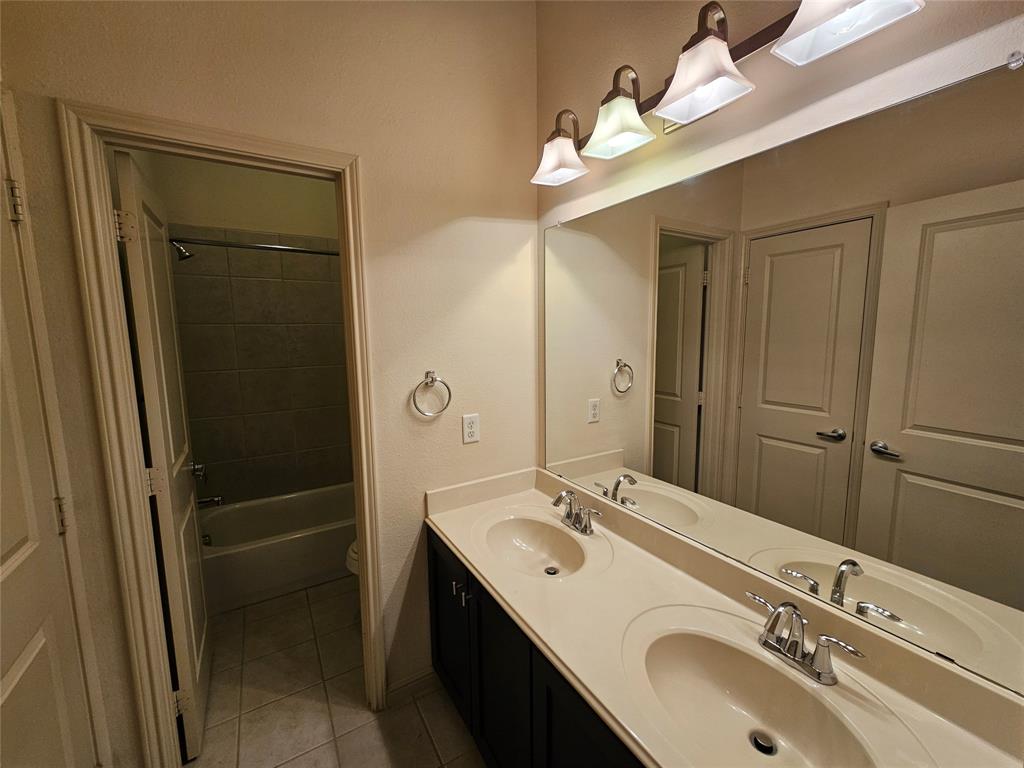 8627 Calvin Road Irving, TX 75063 - Photo 20 of 33 a bathroom with a sink and a mirror
