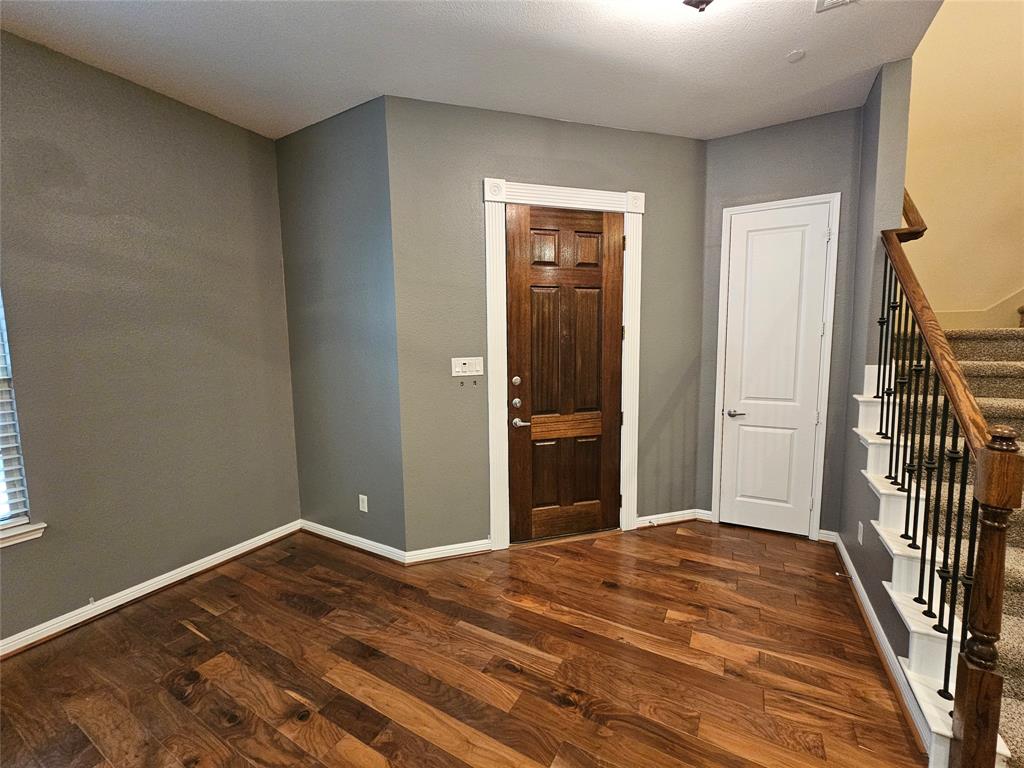 8627 Calvin Road Irving, TX 75063 - Photo 2 of 33 a bedroom with a bed and wooden floor
