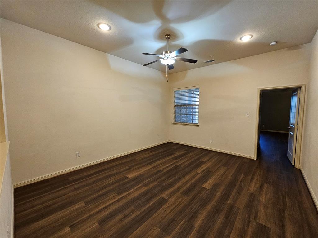 8627 Calvin Road Irving, TX 75063 - Photo 21 of 33 a view of empty room with wooden floor and fan