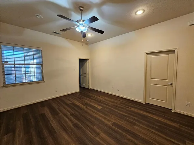 an empty room with a bench and cabinets