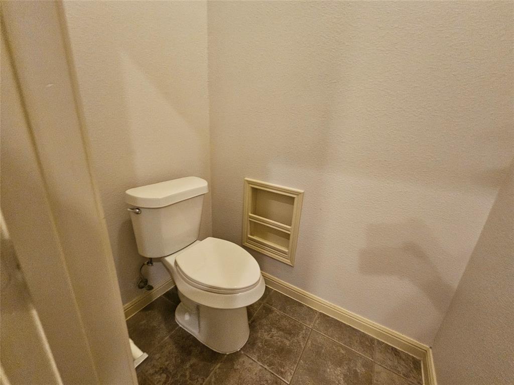 8627 Calvin Road Irving, TX 75063 - Photo 29 of 33 a white toilet sitting next to a shower