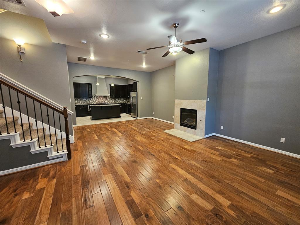 8627 Calvin Road Irving, TX 75063 - Photo 3 of 33 wooden floor in an empty room with a fireplace