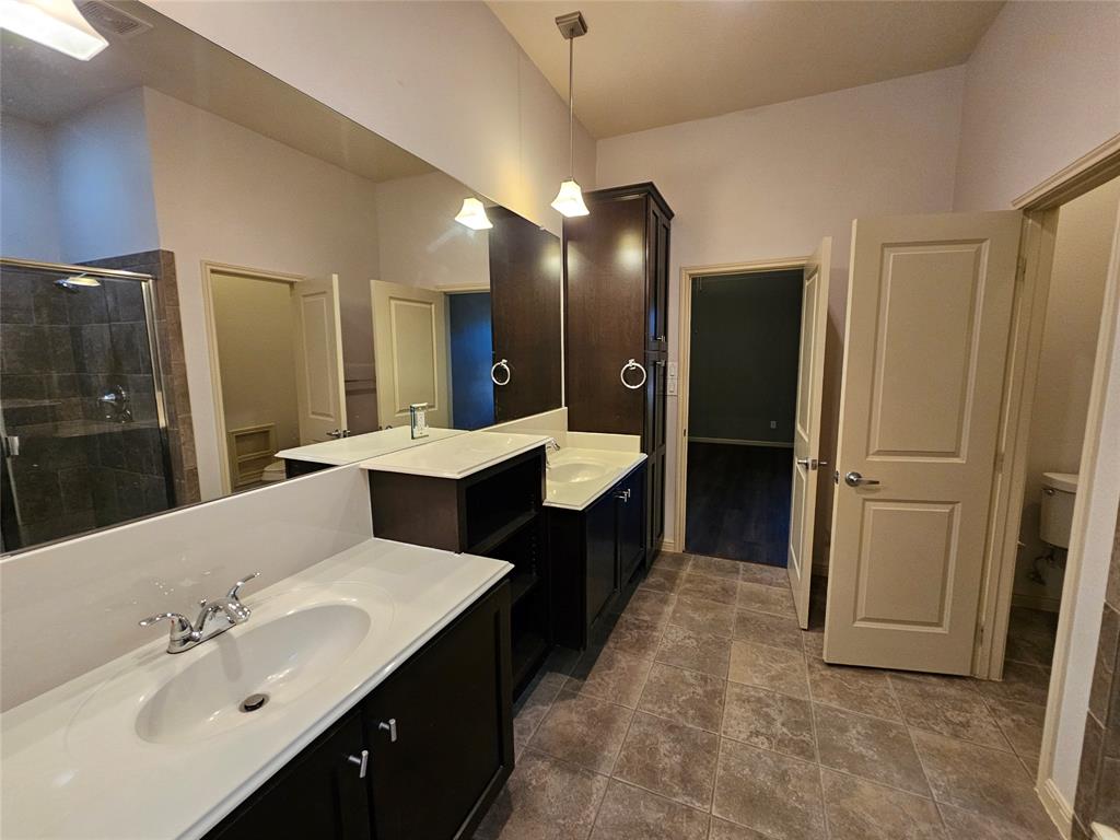 8627 Calvin Road Irving, TX 75063 - Photo 31 of 33 a large bathroom with a double vanity sink and mirror