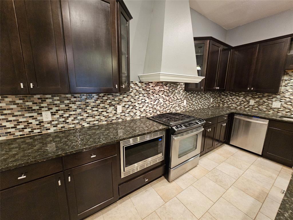 8627 Calvin Road Irving, TX 75063 - Photo 10 of 33 a kitchen with granite countertop a sink and a stove