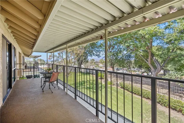 a view of a patio with a table chairs and wooden fence