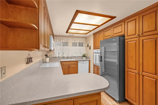 a kitchen with stainless steel appliances a refrigerator and a stove