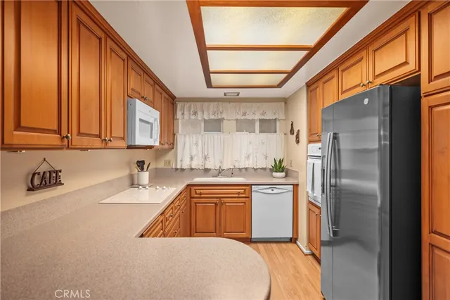 a kitchen with a sink a refrigerator and cabinets