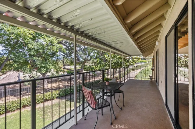 a view of a chairs and table in the balcony