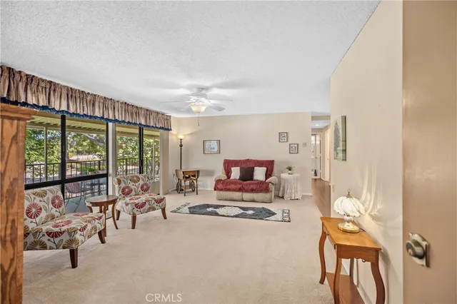 a living room with furniture and a floor to ceiling window