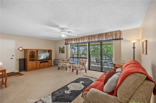 a living room with furniture and large flat screen tv
