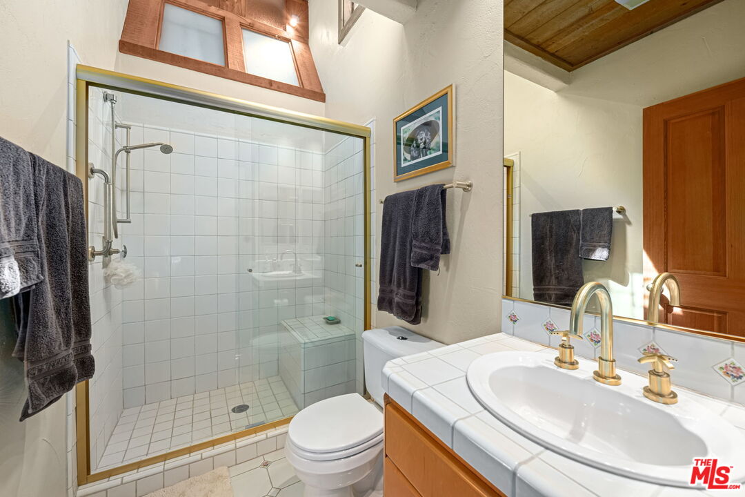13360 Chalon Road Los Angeles, CA 90049 - Photo 27 of 69 a bathroom with a sink a toilet and shower