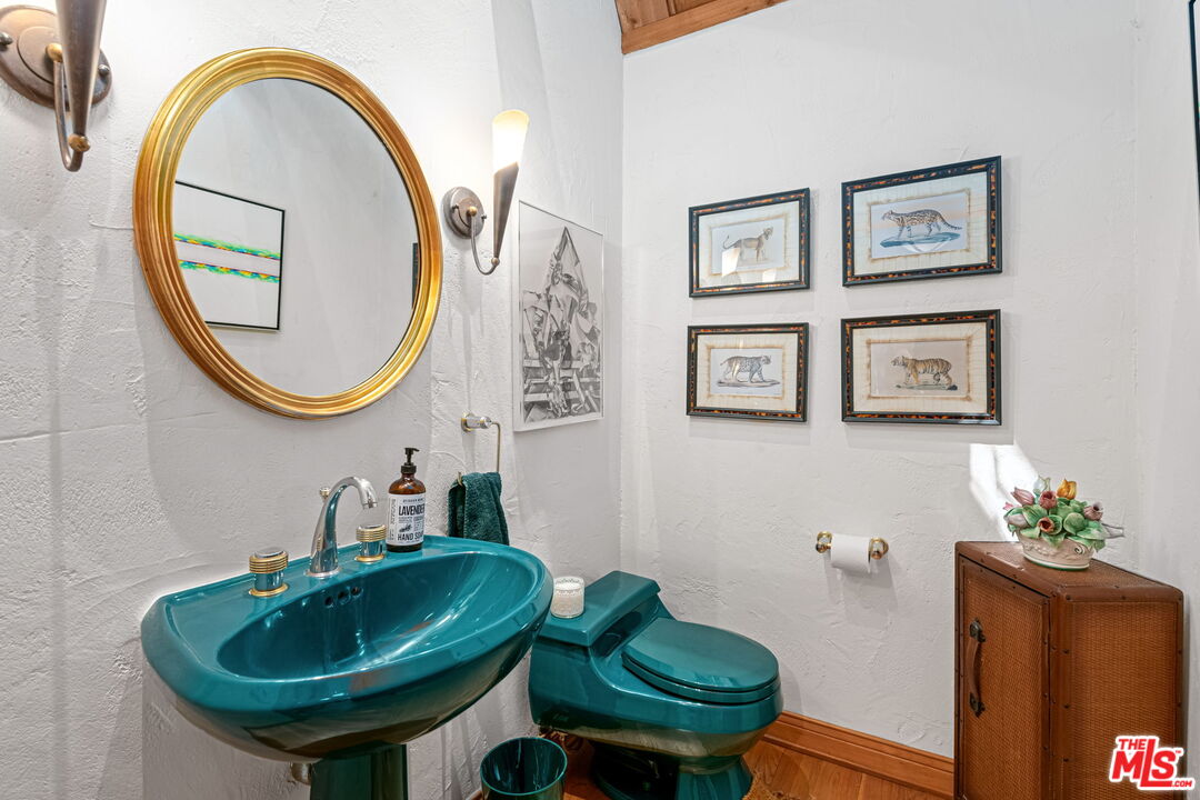 13360 Chalon Road Los Angeles, CA 90049 - Photo 29 of 69 a bathroom with a sink and a mirror