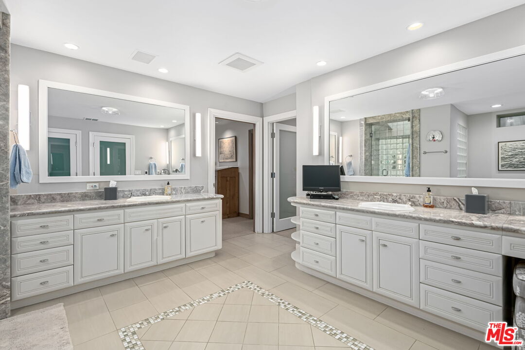 13360 Chalon Road Los Angeles, CA 90049 - Photo 43 of 69 a large bathroom with a granite countertop double vanity sink and a mirror