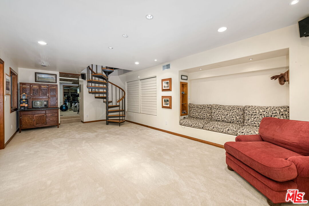 13360 Chalon Road Los Angeles, CA 90049 - Photo 47 of 69 a living room with furniture and a flat screen tv