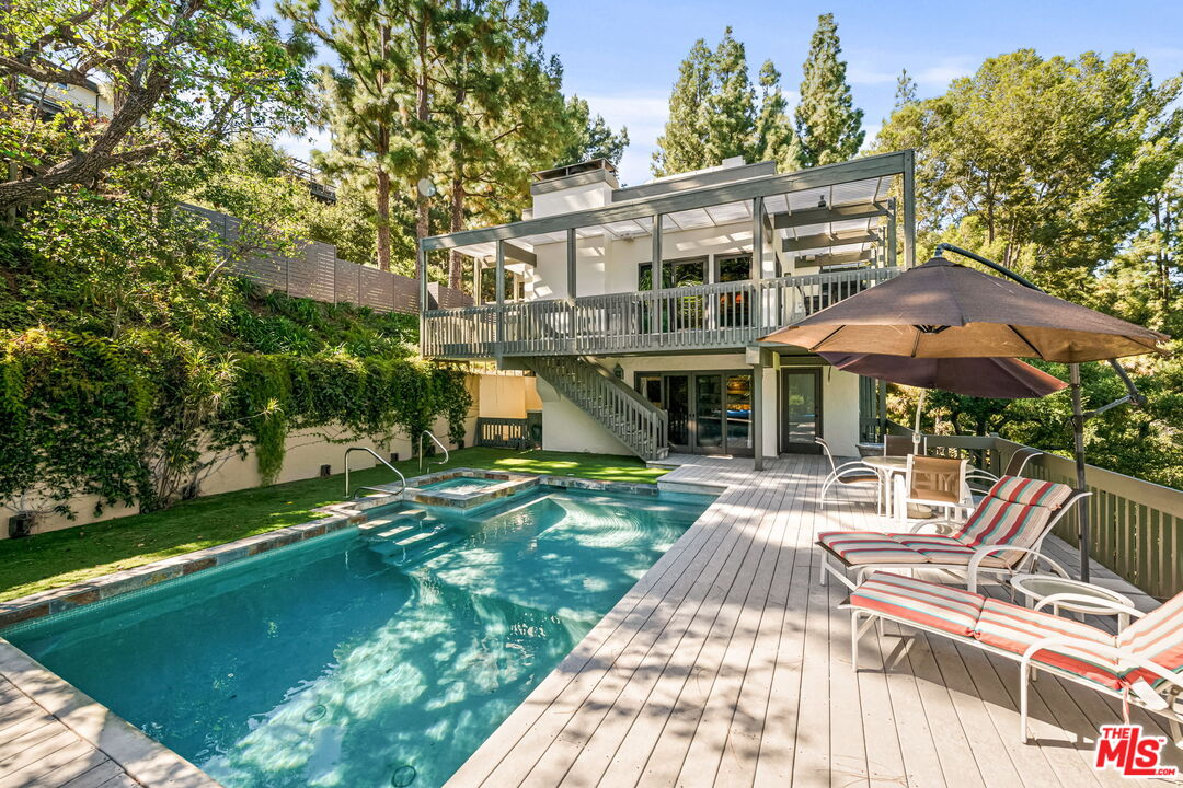 13360 Chalon Road Los Angeles, CA 90049 - Photo 59 of 69 a front view of a house with a yard table and chairs