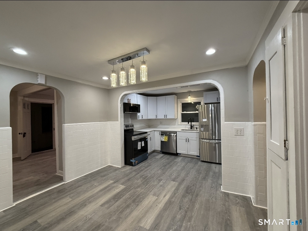 12 Mechanic Street Moosup, CT 06354 - Photo 2 of 8 a kitchen with stainless steel appliances granite countertop a refrigerator and a stove top oven