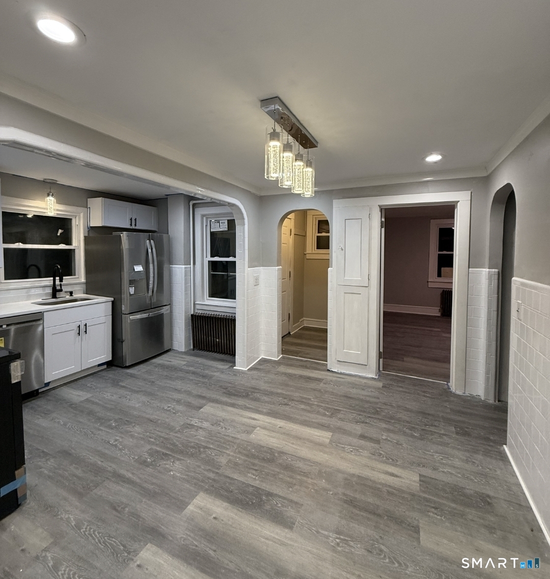 12 Mechanic Street Moosup, CT 06354 - Photo 3 of 8 a view of a kitchen with a sink and a refrigerator