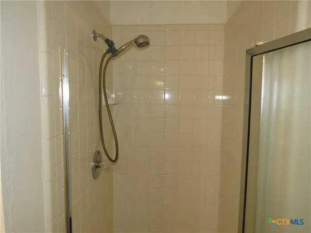 a bathroom with a glass shower door