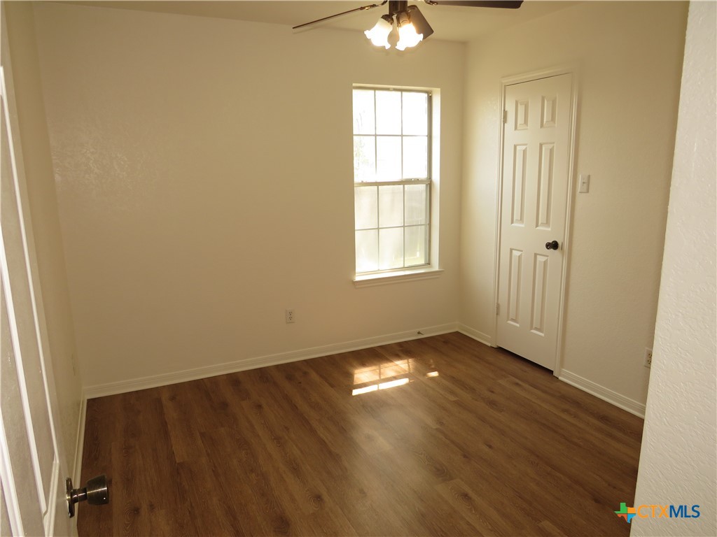 5009 James Loop Killeen, TX 76542 - Photo 17 of 24 an empty room with wooden floor fan and windows