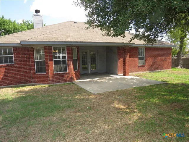 a front view of a house with a garden and yard