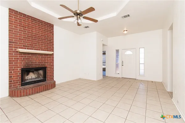 a view of an empty room with a fireplace