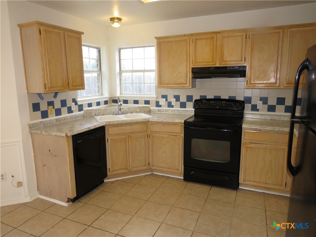 5009 James Loop Killeen, TX 76542 - Photo 5 of 24 a kitchen with a stove sink and cabinets