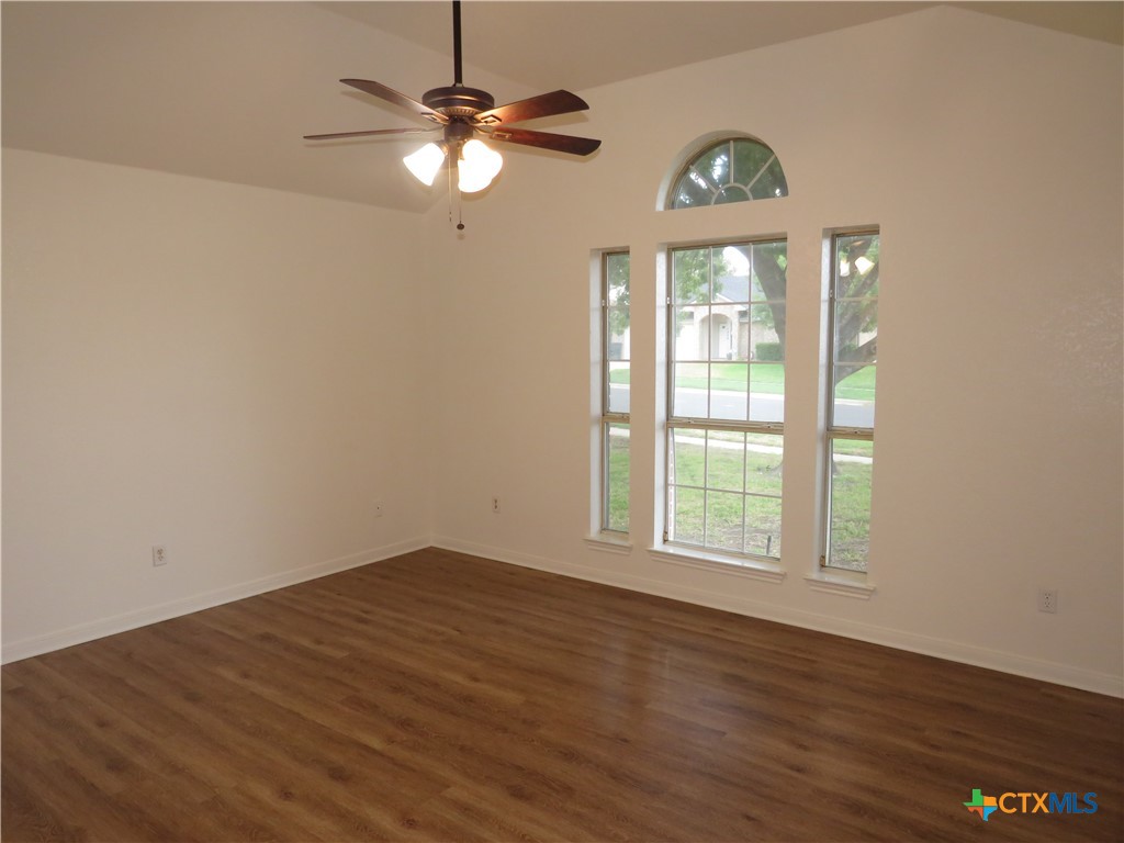 5009 James Loop Killeen, TX 76542 - Photo 7 of 24 an empty room with wooden floor fan and windows