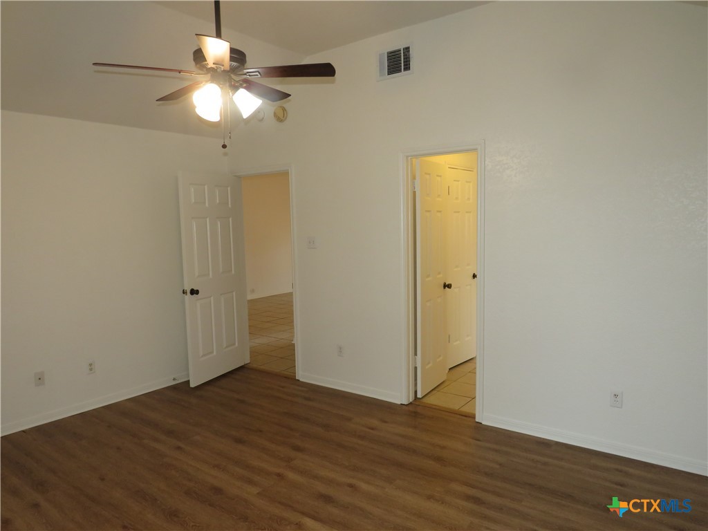 5009 James Loop Killeen, TX 76542 - Photo 8 of 24 an empty room with wooden floor and windows
