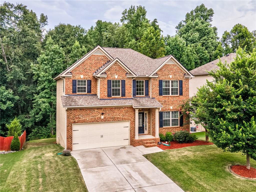 5120 Bucknell Trace Cumming, GA 30028 - Photo 1 of 1 a front view of a house with a yard and trees