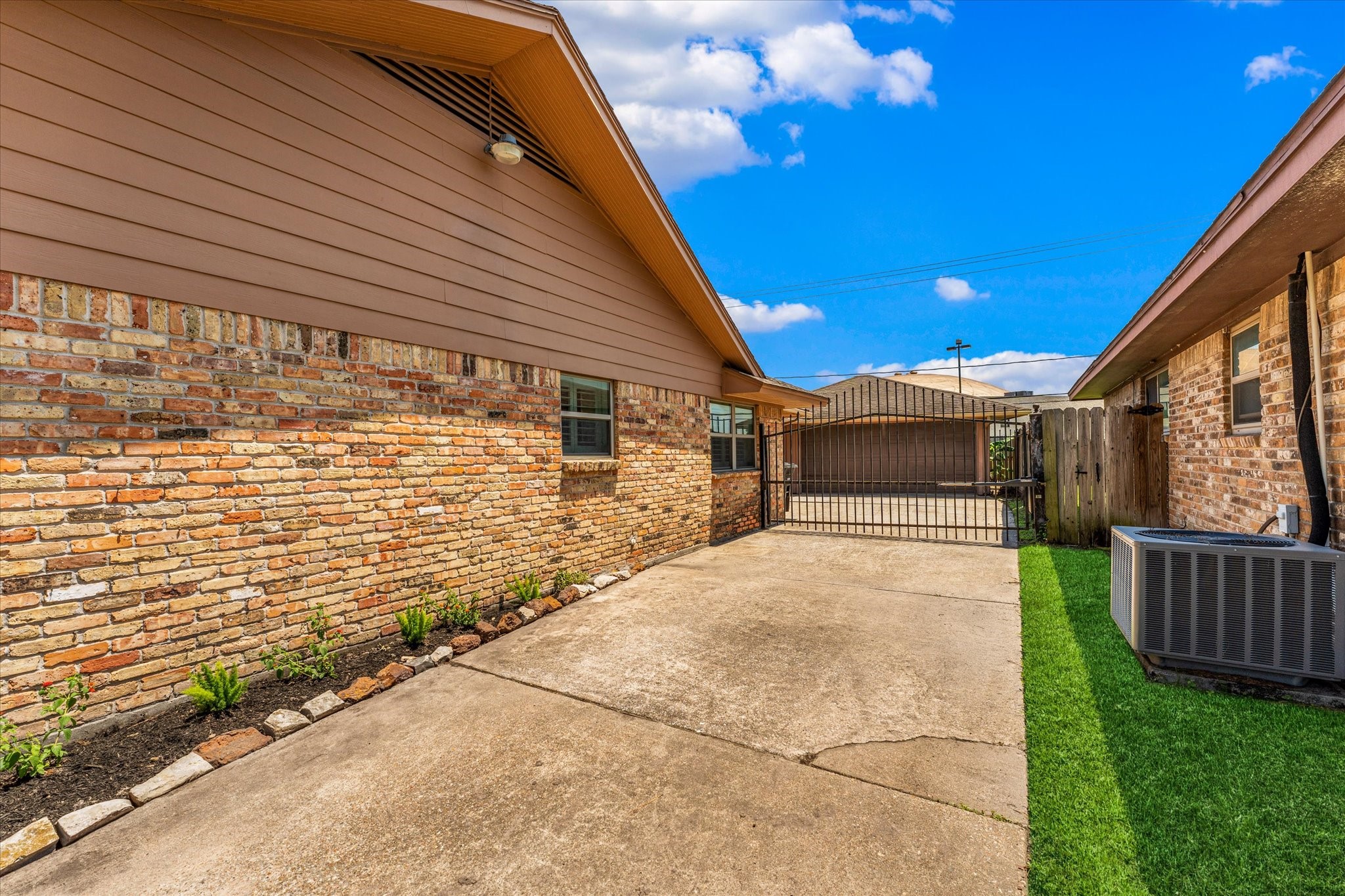 983 West Donovan Street Houston, TX 77091 - Photo 42 of 46 Driveway with automatic electric gate opener