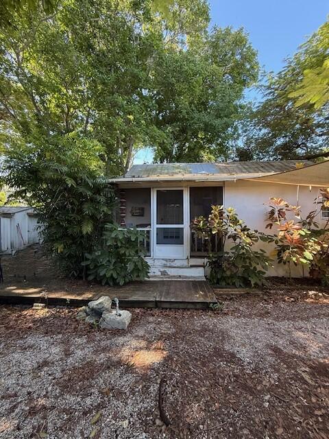 708 Bakers Lane Key West, FL 33040 - Photo 4 of 9 a view of a house with a yard and large tree