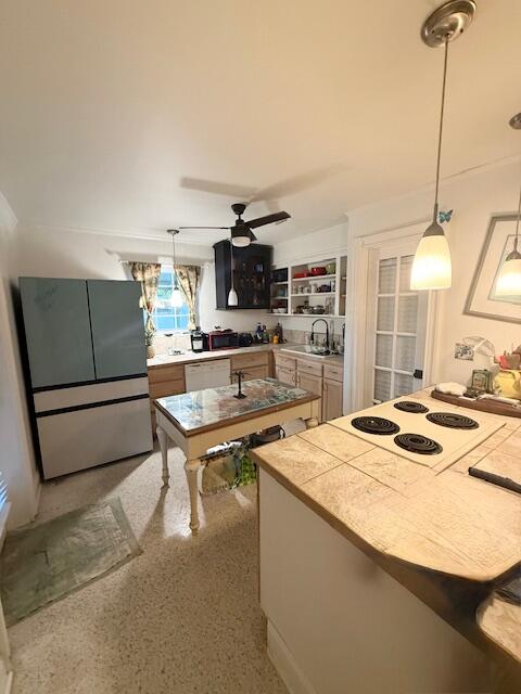 708 Bakers Lane Key West, FL 33040 - Photo 8 of 9 a kitchen with a appliances a stove a sink and a refrigerator