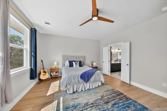 a bedroom with a large bed and a chandelier