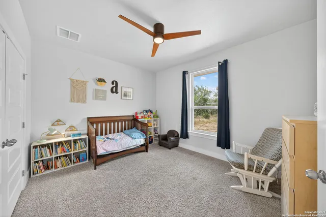 a bedroom with furniture and a window