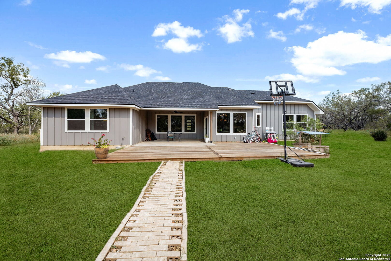 558 County Road 7713 Devine, TX 78016 - Photo 24 of 33 a front view of a house with a garden