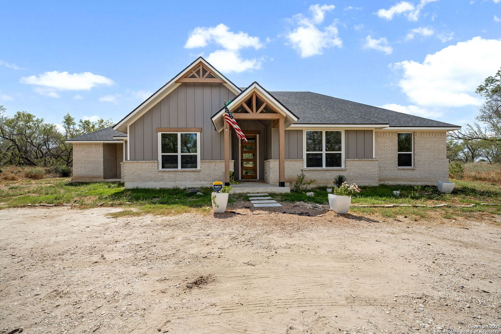 558 County Road 7713 Devine, TX 78016 - Photo 28 of 33 a front view of house with yard and trees