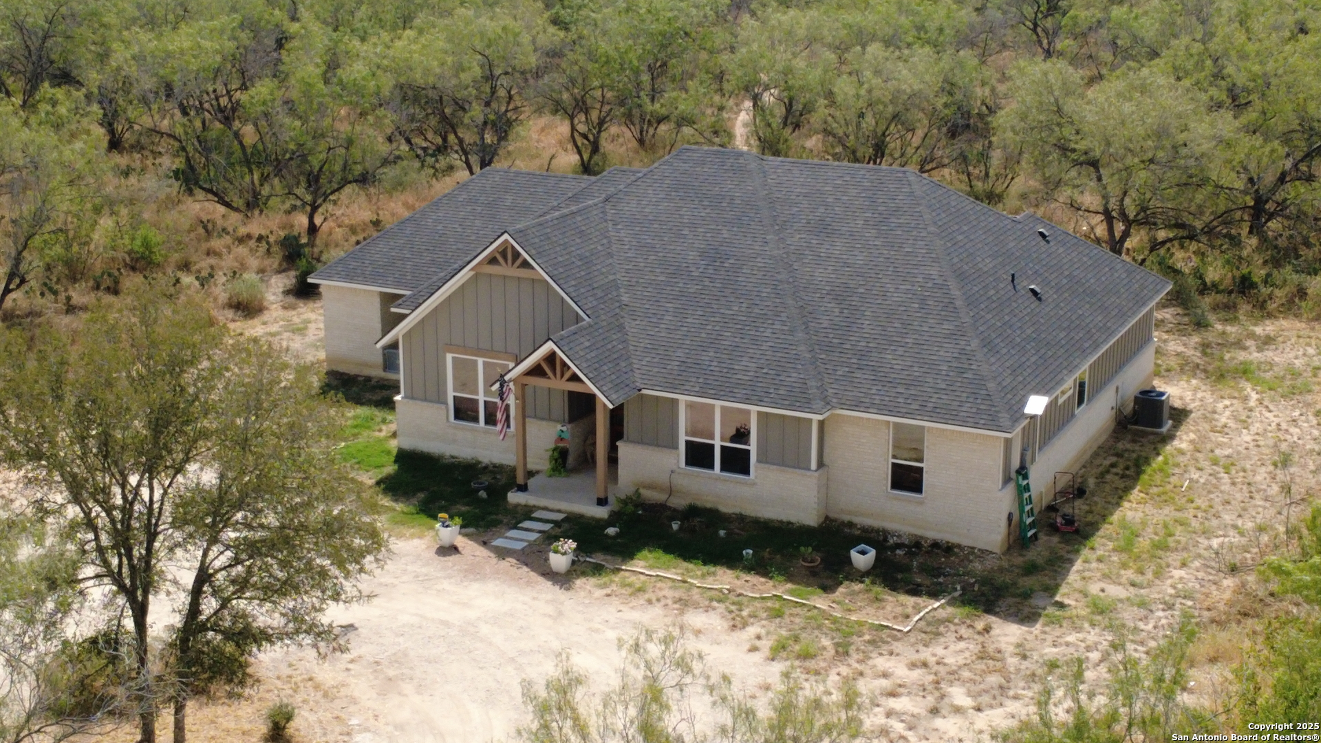 558 County Road 7713 Devine, TX 78016 - Photo 29 of 33 a aerial view of a house with a yard