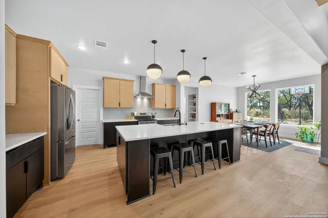 a large kitchen with a table and chairs