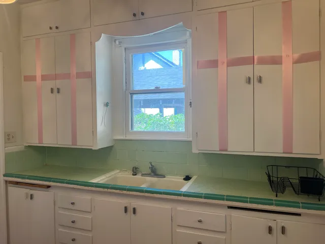 a kitchen with a sink and cabinets